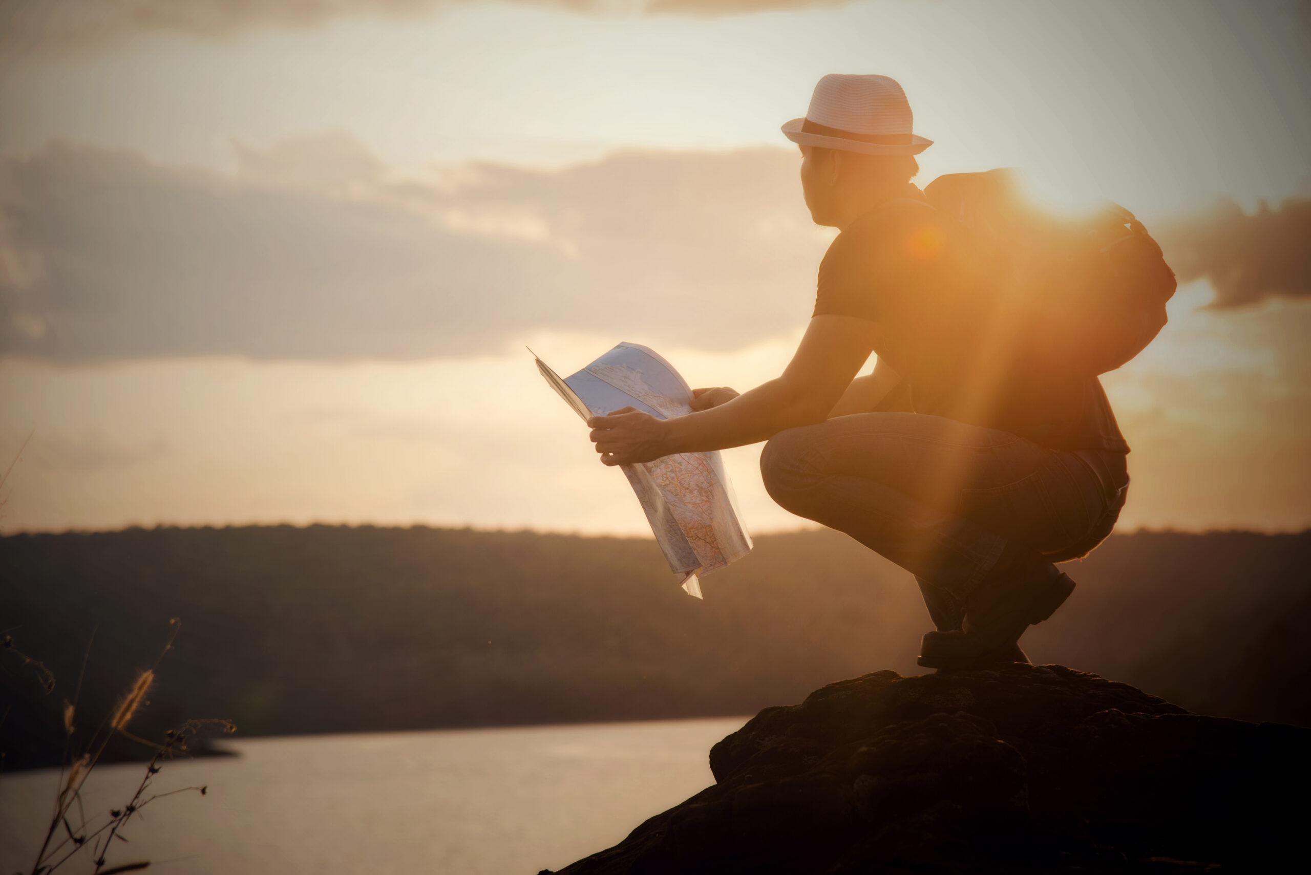 Tourist making photo of the nature, Man with map exploring wilderness on trekking adventure